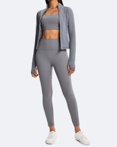 Model wearing a grey 3 piece eco-friendly activewear set with jacket