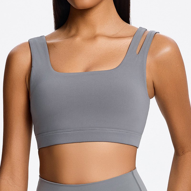 Woman wearing a sustainable eco-friendly square neck sports bra in grey