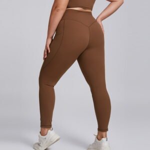 Woman wearing plus size high waist yoga leggings with pockets