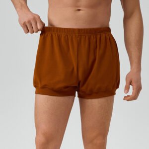 Model wearing comfortable men's cotton loose yoga shorts for workout
